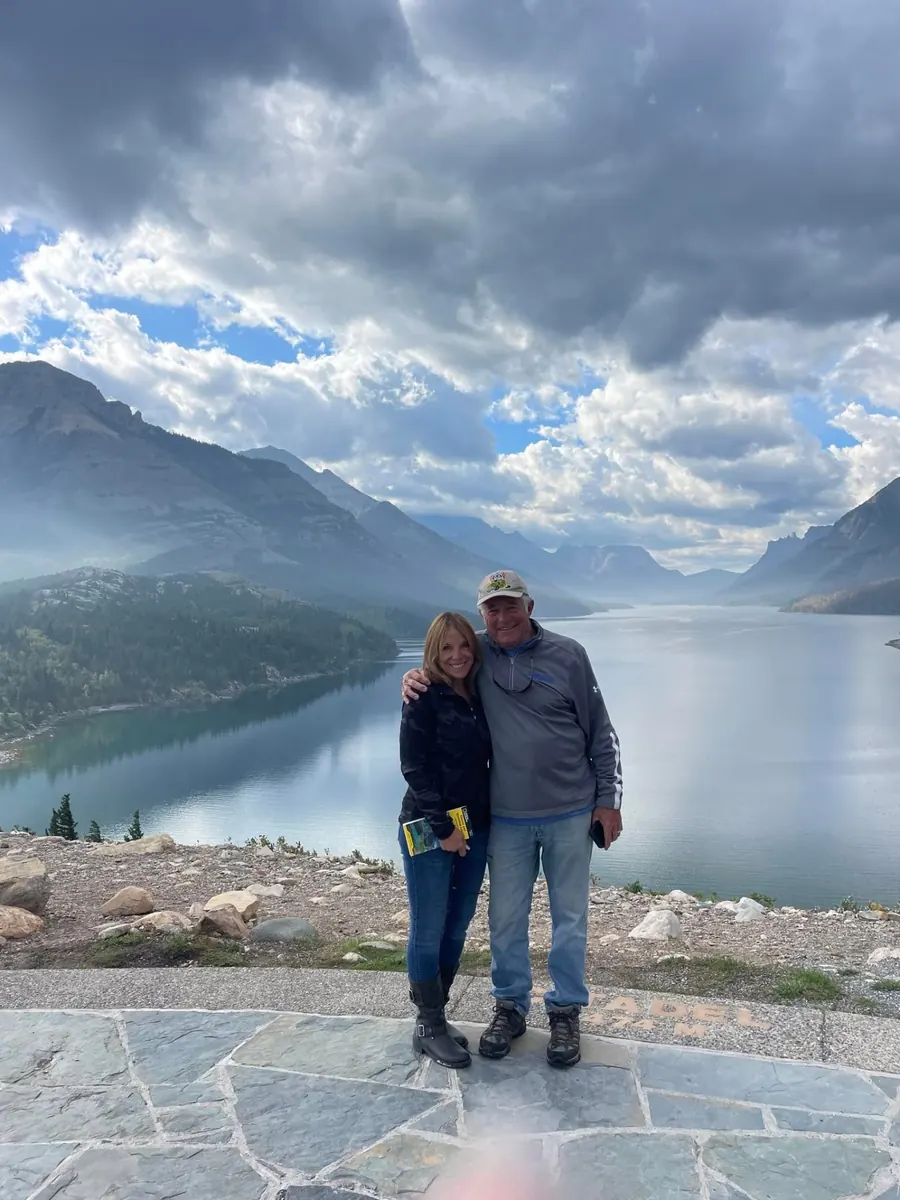 Diane Beaumont and her husband at a Colorado mountain lake overlook